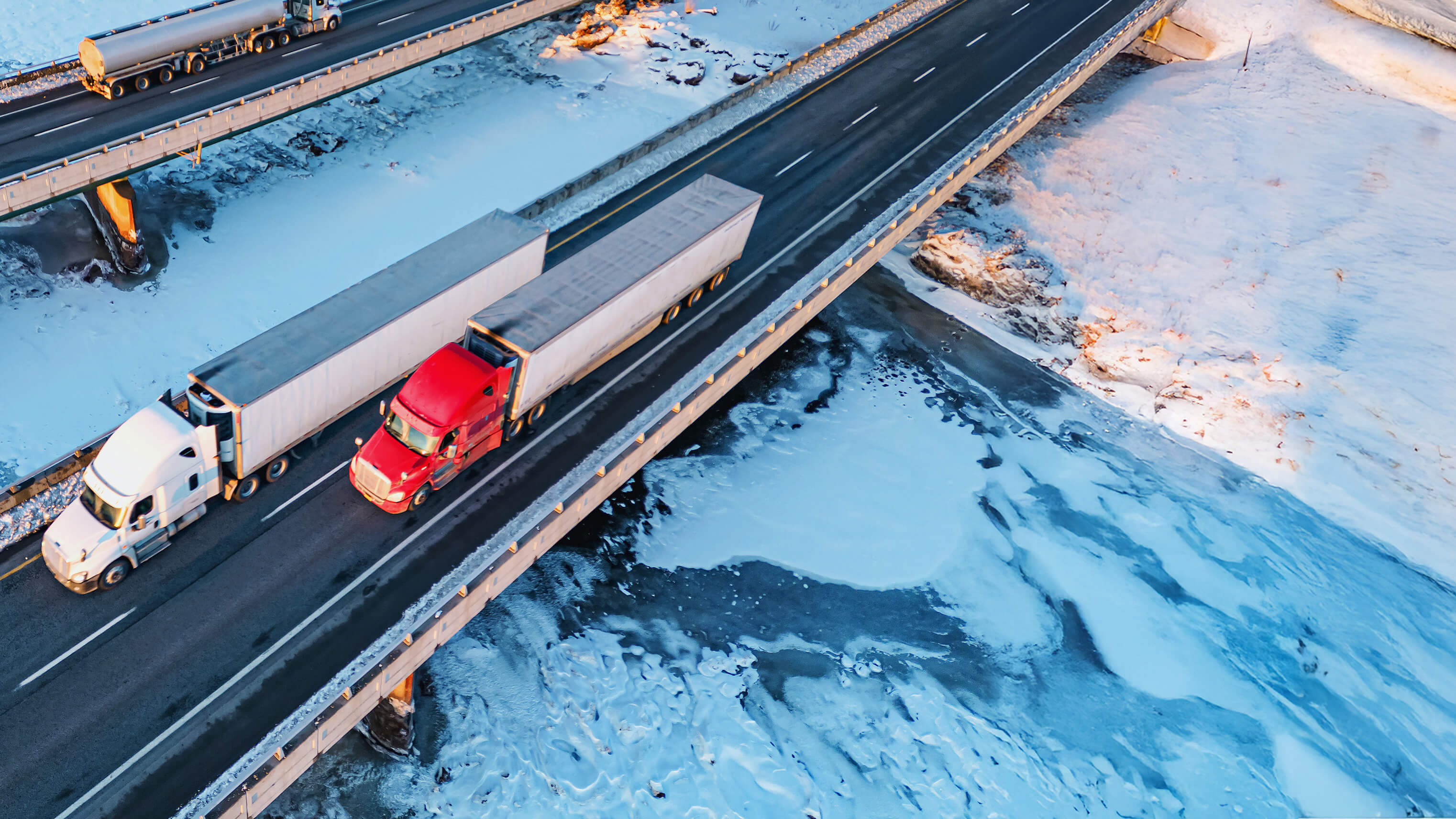 Two trucks on a snowy highway