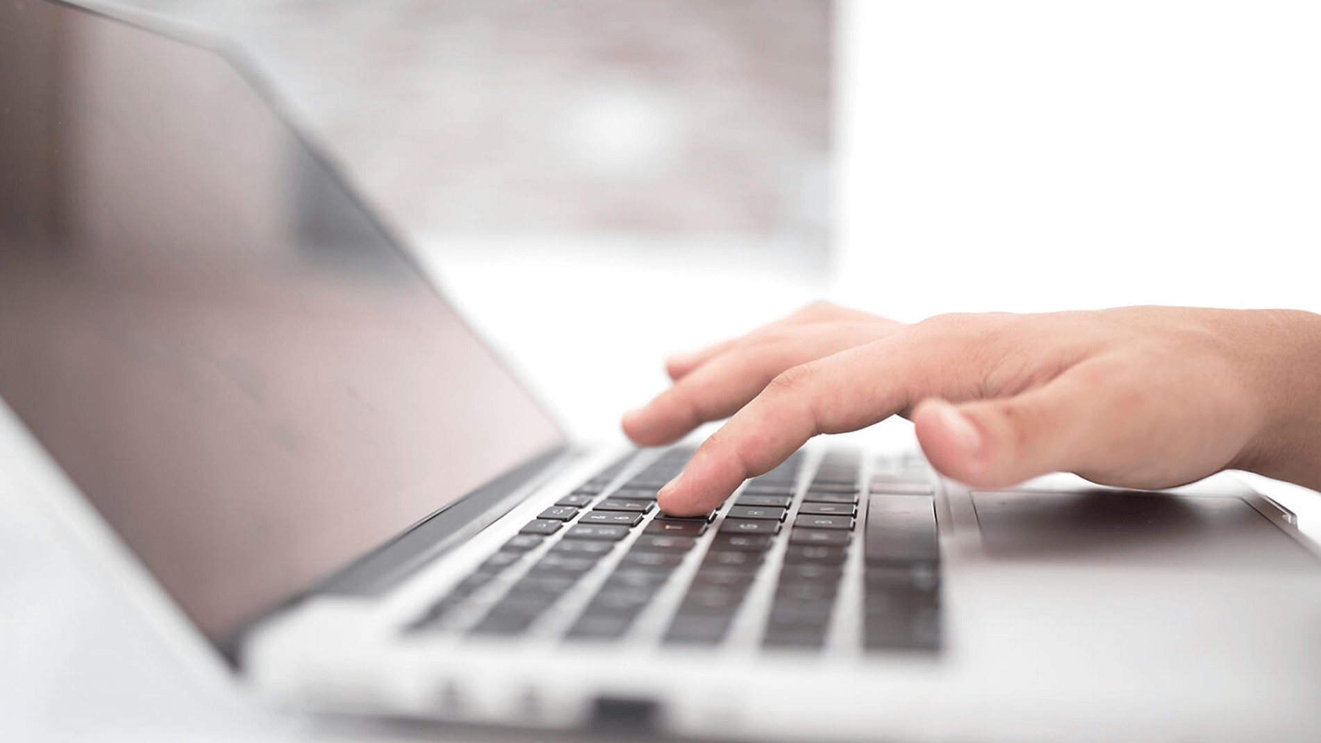 advanced-production-readiness-1902x1070.png Image of a hand typing on a keyboard of a laptop computer.
