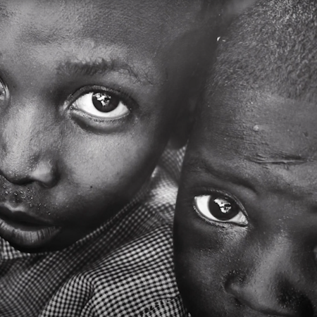 Two children in a black in white photo.