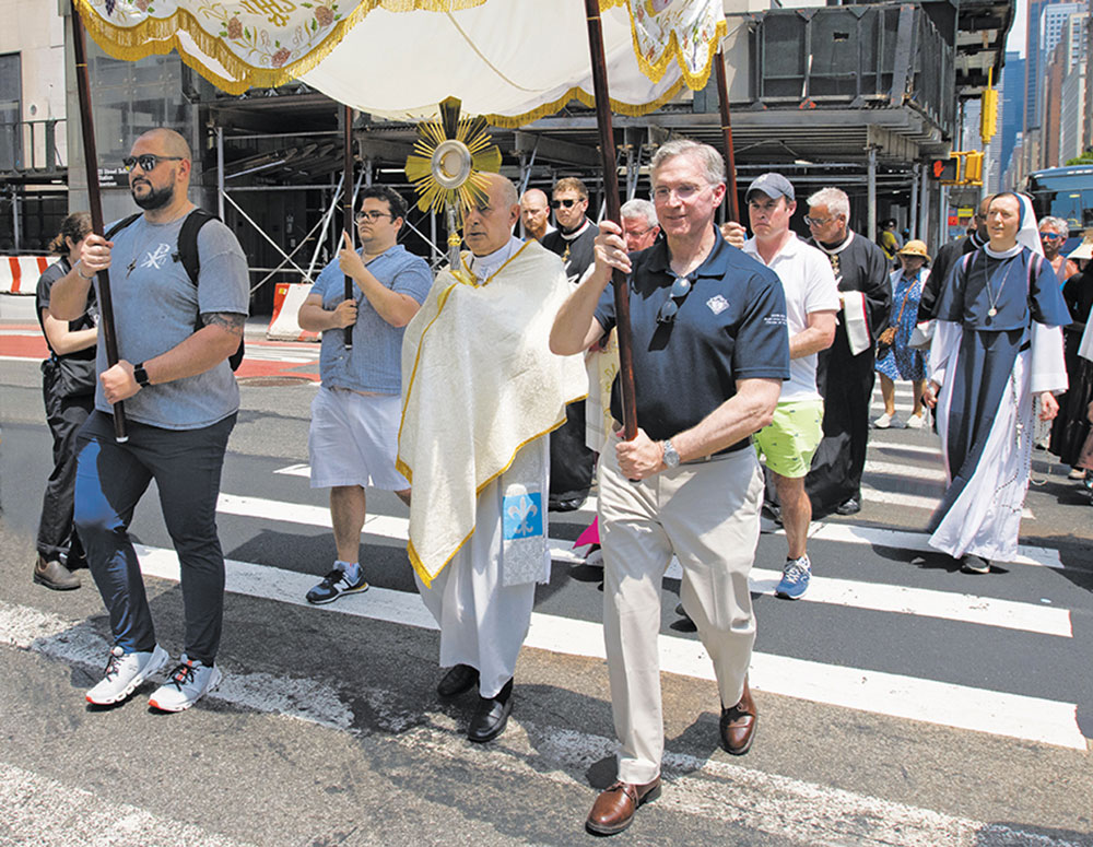 The Blessed Sacrament is carried through New York City on May 26 by Archbishop Gabriele Caccia, apostolic nuncio and permanent observer of the Holy See to the United Nations. Supreme Knight Patrick Kelly helped carry the canopy for the procession, part of the Seton Route of the National Eucharistic Pilgrimage. (Photo by Jeffrey Bruno)