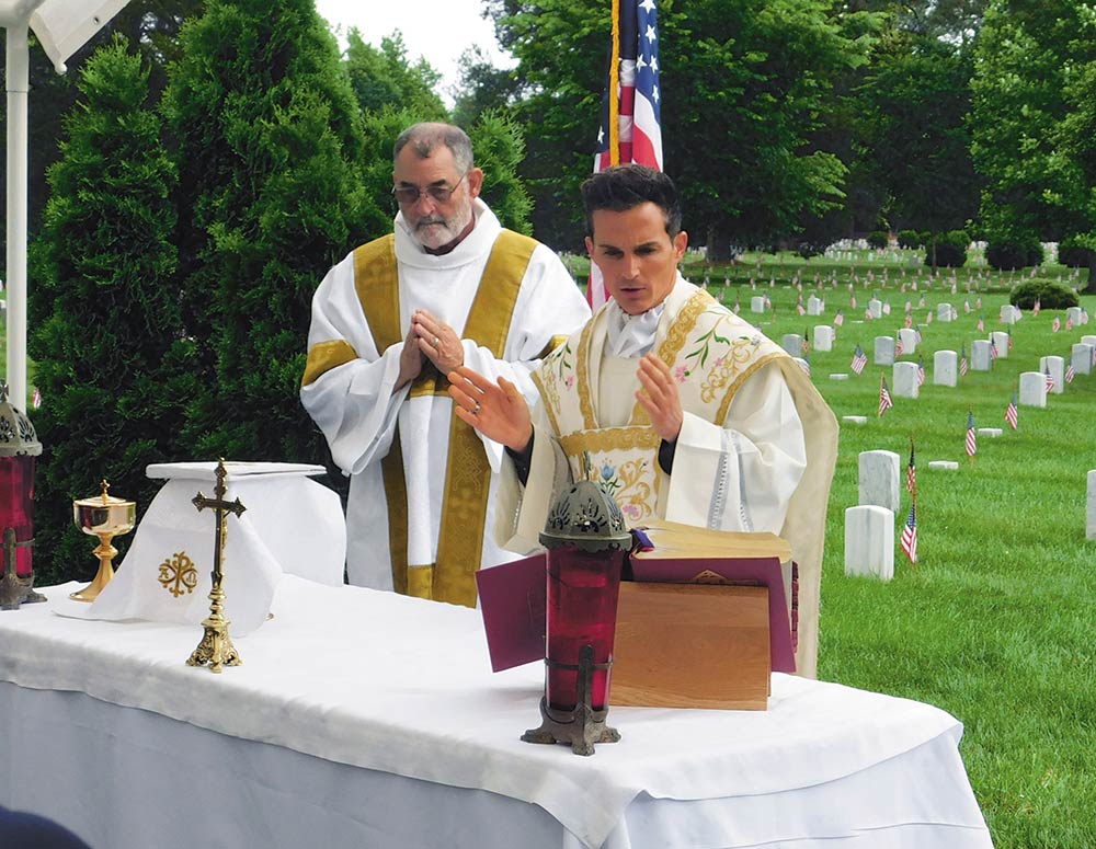 Father Gino Rossi celebrates Mass at Poplar Grove National Cemetery in Petersburg, Va., May 27. Petersburg Council 694 has held an annual Memorial Day Mass at the cemetery for more than 60 years. In 2024, a permit for the Mass was initially denied but later granted after the Knights brought a lawsuit against the National Park Service. (Photo by Steve Eilert)