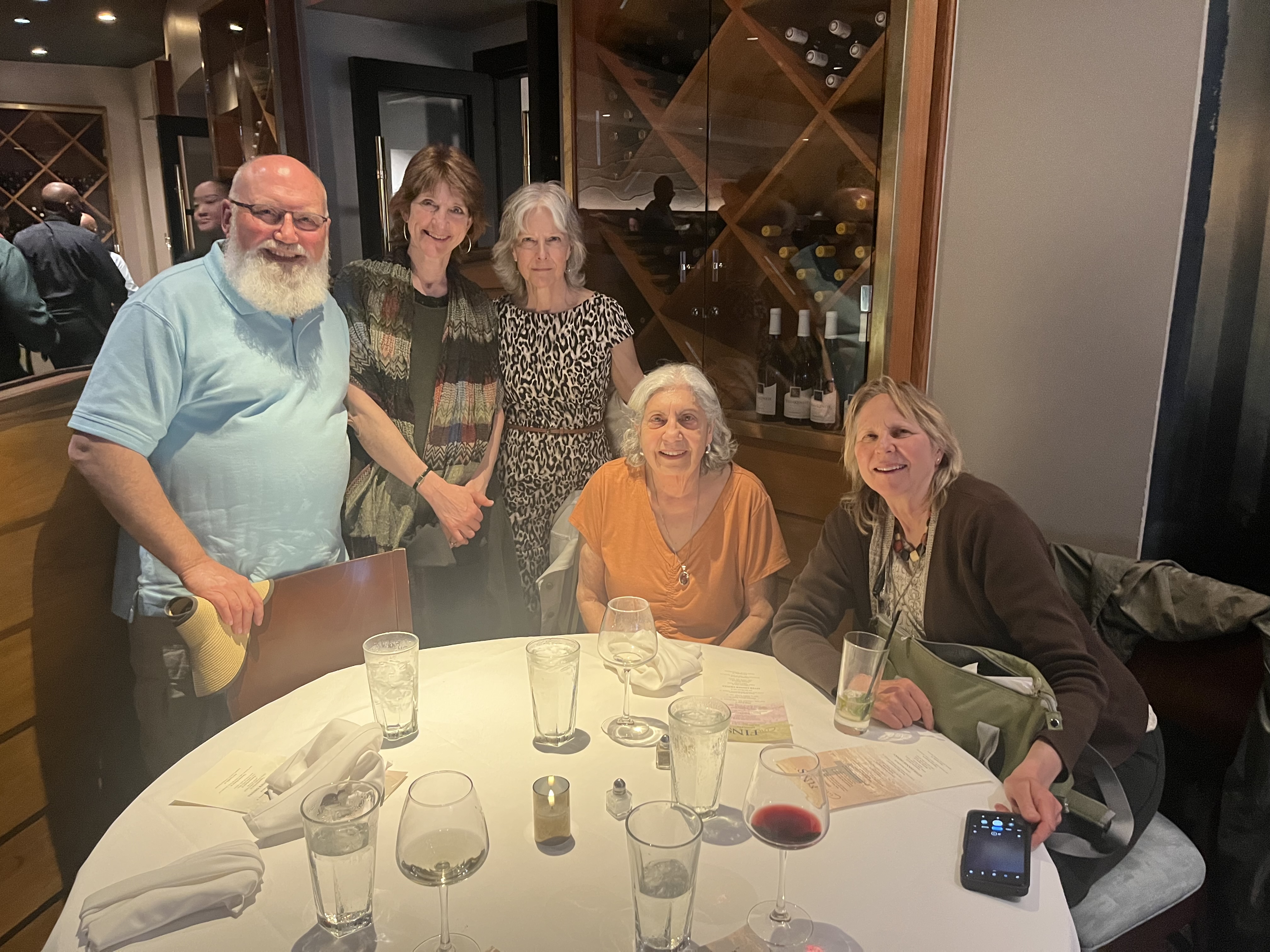 Barbara and friends smile around the dinner table