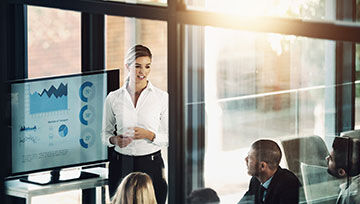 A group of people in a business meeting reviewing a budget