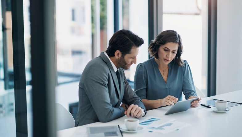 Two business people working on tablet
