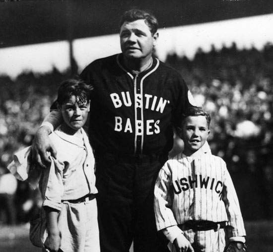 Babe Ruth poses with two young Brooklyn fans