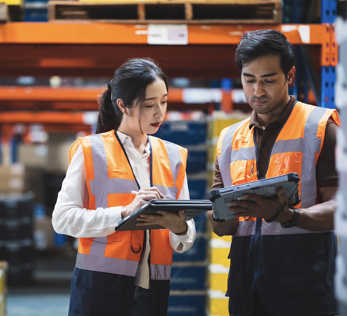 Warehouse workers comparing notes