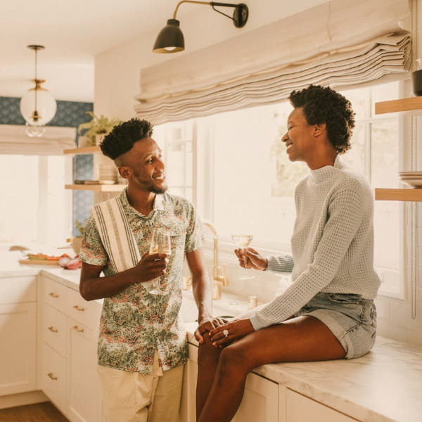 happy couple having drinks in the kitchen
