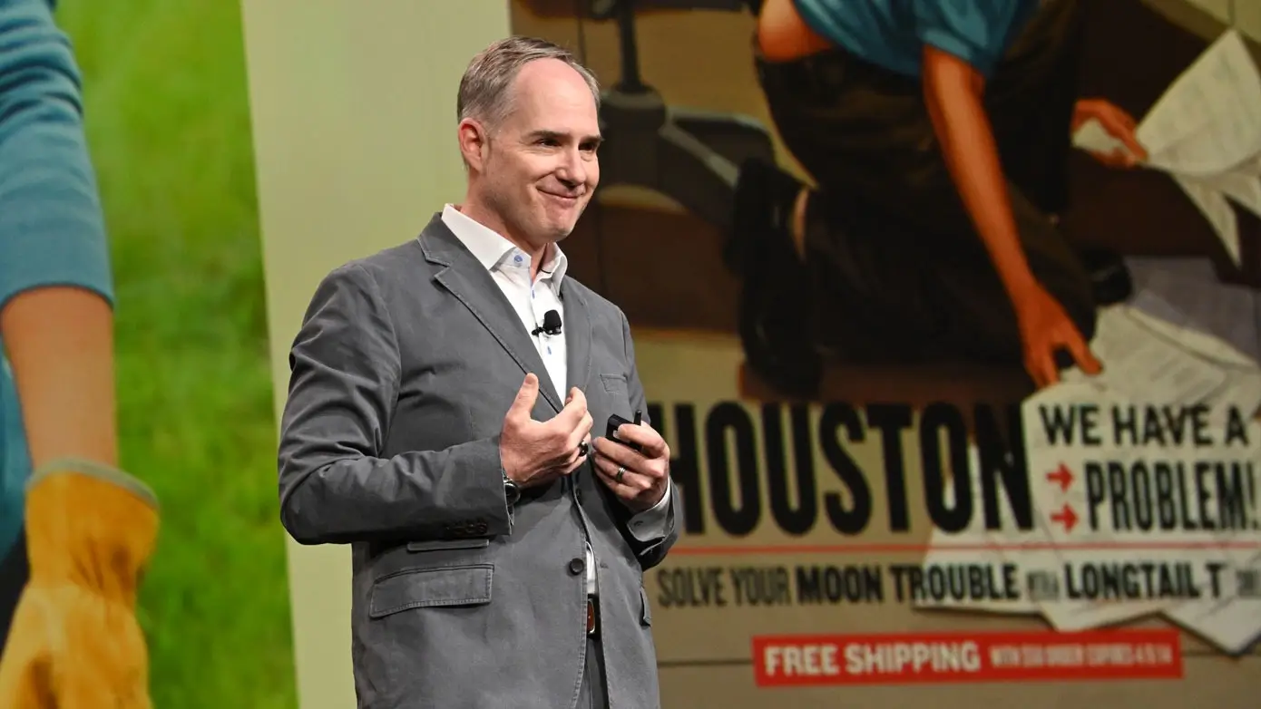 A man speaking on a stage at momentum 2025