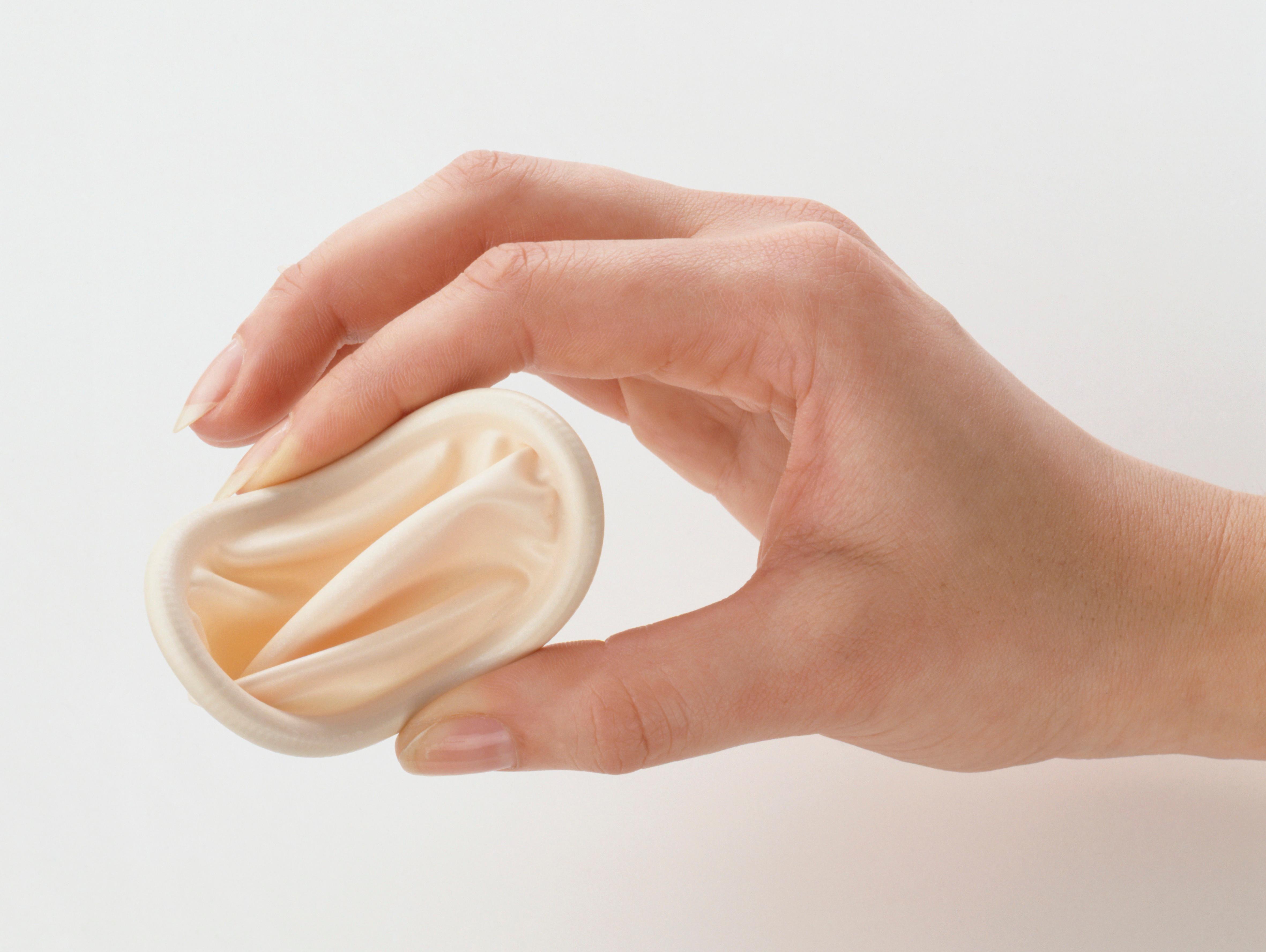 Image of a hand holding a diaphragm, they are applying pressure with their pointer finger and thumb to emphasis the flexibility.