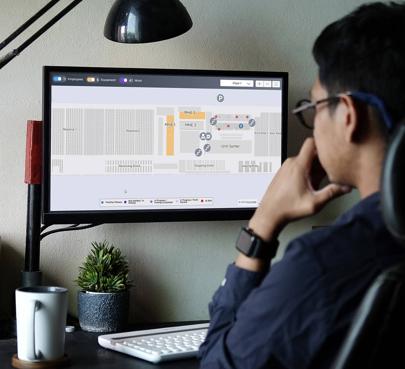 Man looking at Manhattan software on a monitor