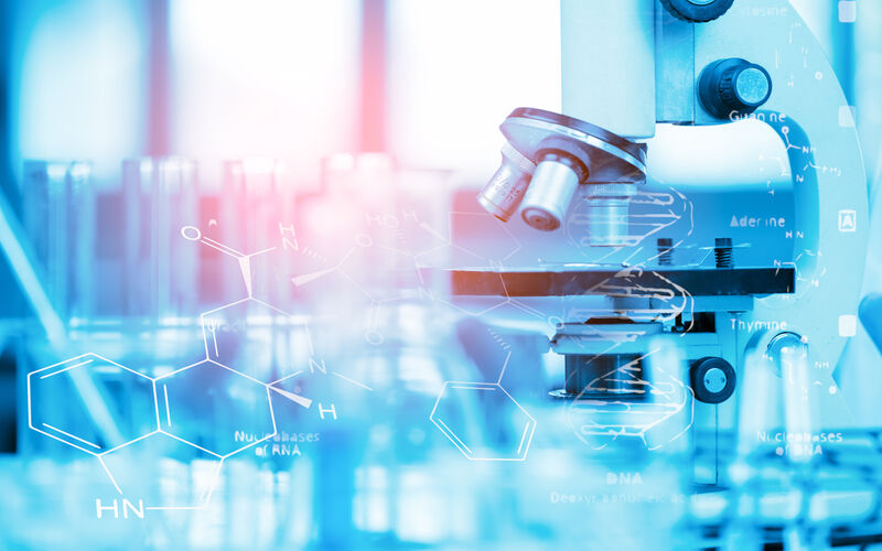 image of a microscope and beakers with a chemical formula superimposed over the top