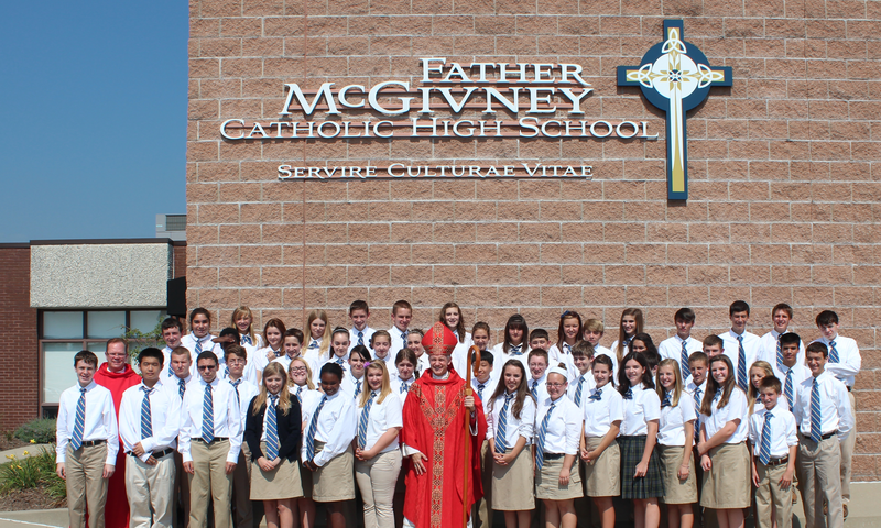A priest and students outside McGivney Catholic High School, Glen Carbon, Illinois.