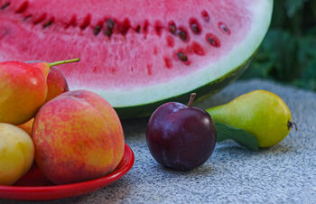 showing fruits like watermelon, peaches, pears, plums