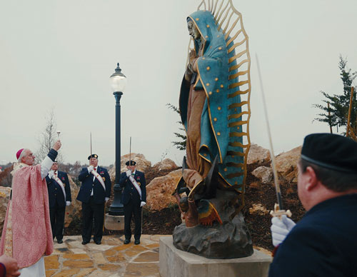 Archbishop Paul Coakley blesses the statue of Our Lady of Guadalupe atop the shrine&rsquo;s Tepeyac Hill
