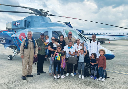 Matos and Marinello gather on the tarmac at Cap-Ha&iuml;tien International Airport with the 14 U.S. citizens they rescued during their second mission trip March 20. (Photo courtesy of Anthony Marinello)