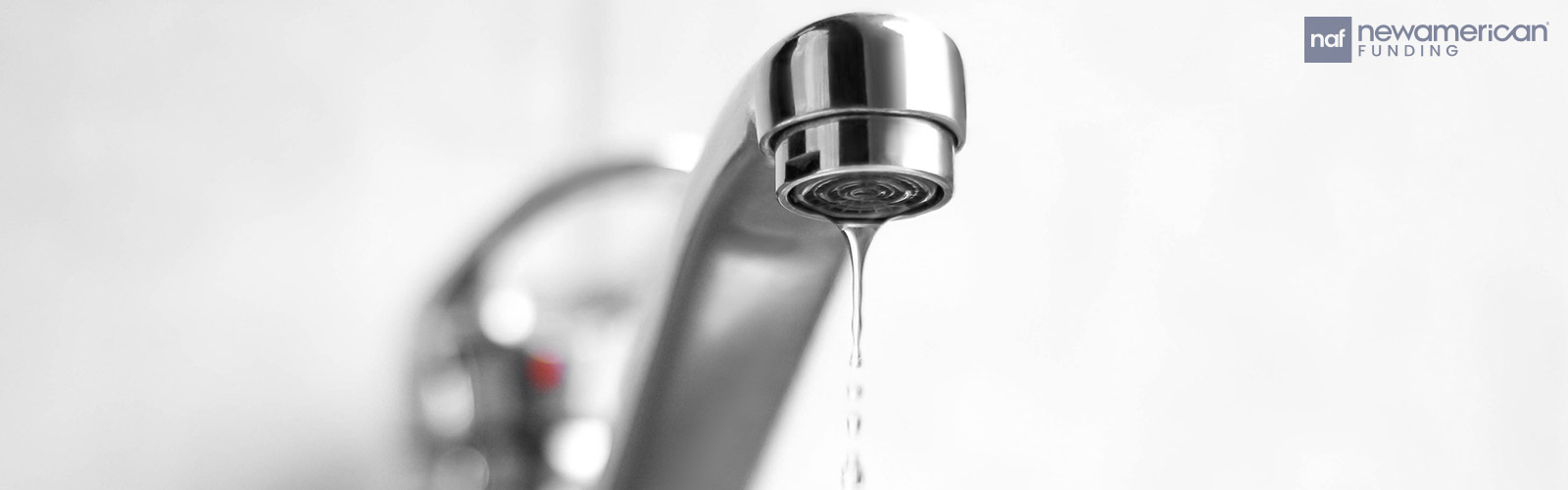 A sink faucet dripping water