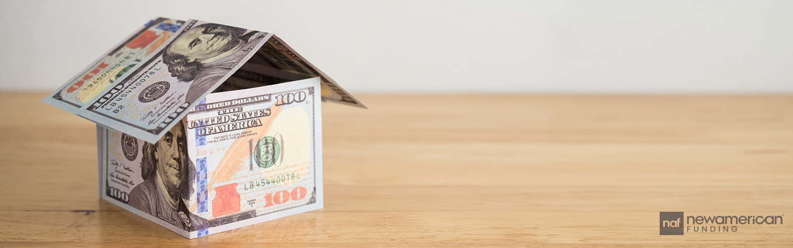model house made of hundred dollar bills