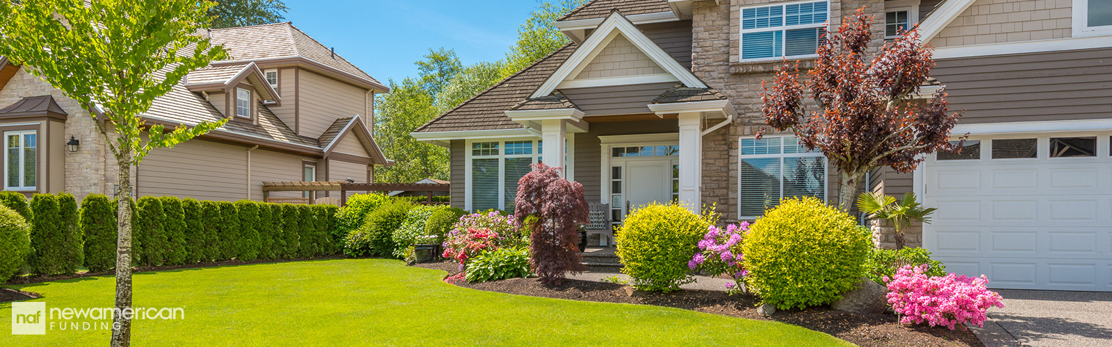 A nice home made with grey siding sitting on a tamed lawn