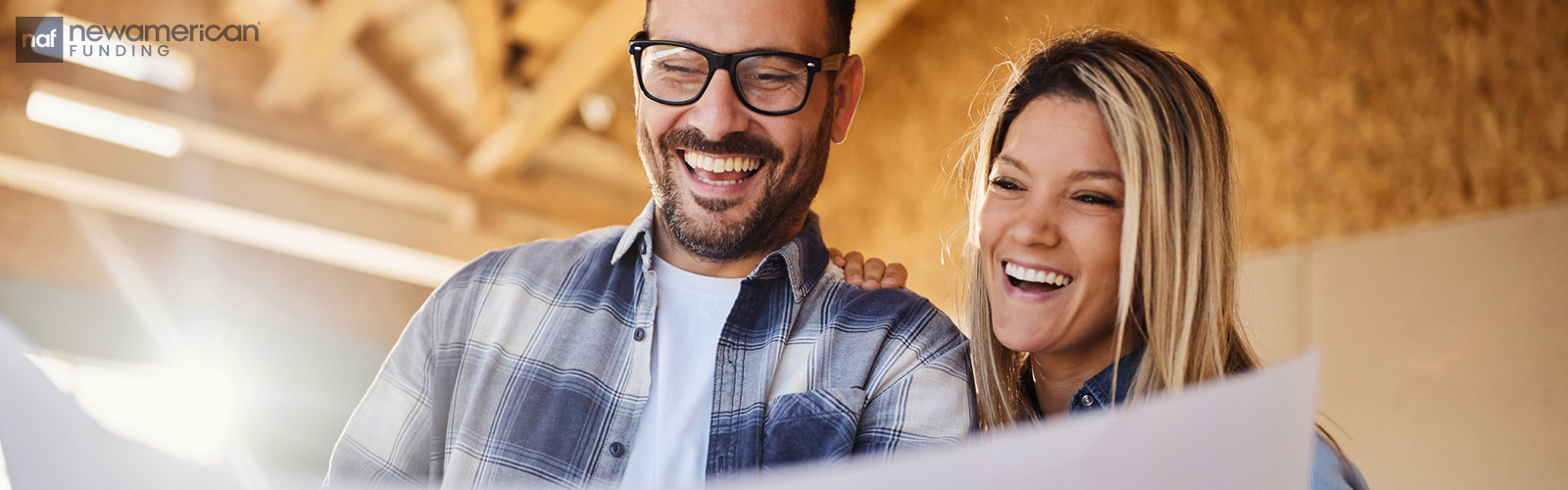 happy couple looking at their house plan