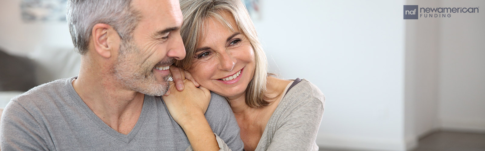 An older white man and white woman sit smiling together
