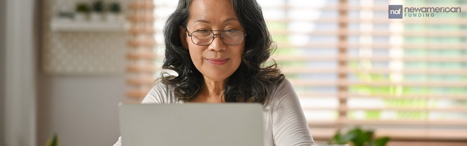 mature asian woman on her laptop