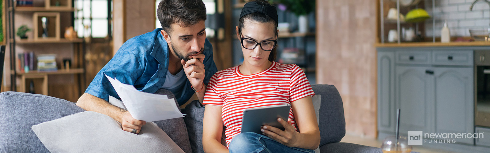 couple going over paperwork on the couch in the living room