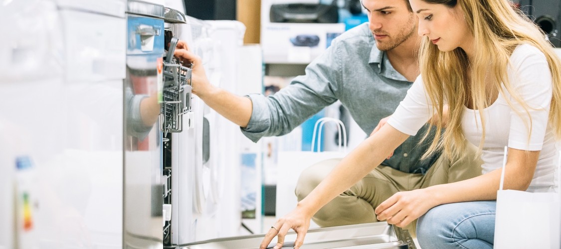 A couple looking at a new dishwasher