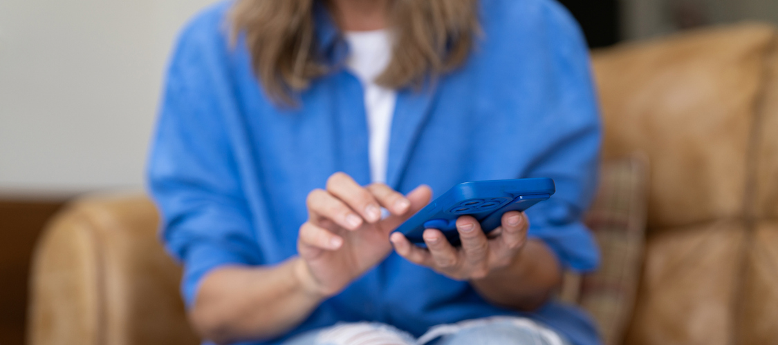 Woman reviewing her finances on a cell phone