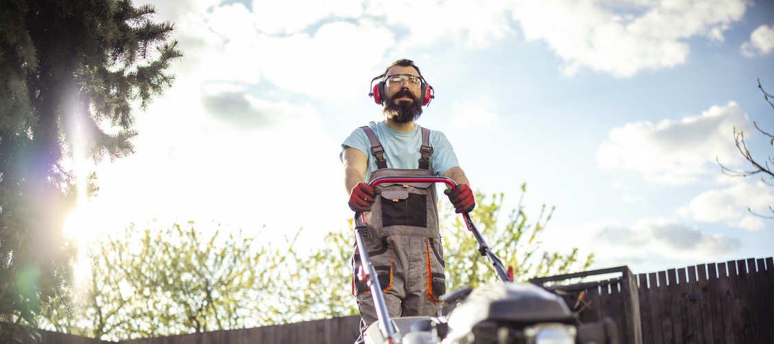 A man mowing a yard.
