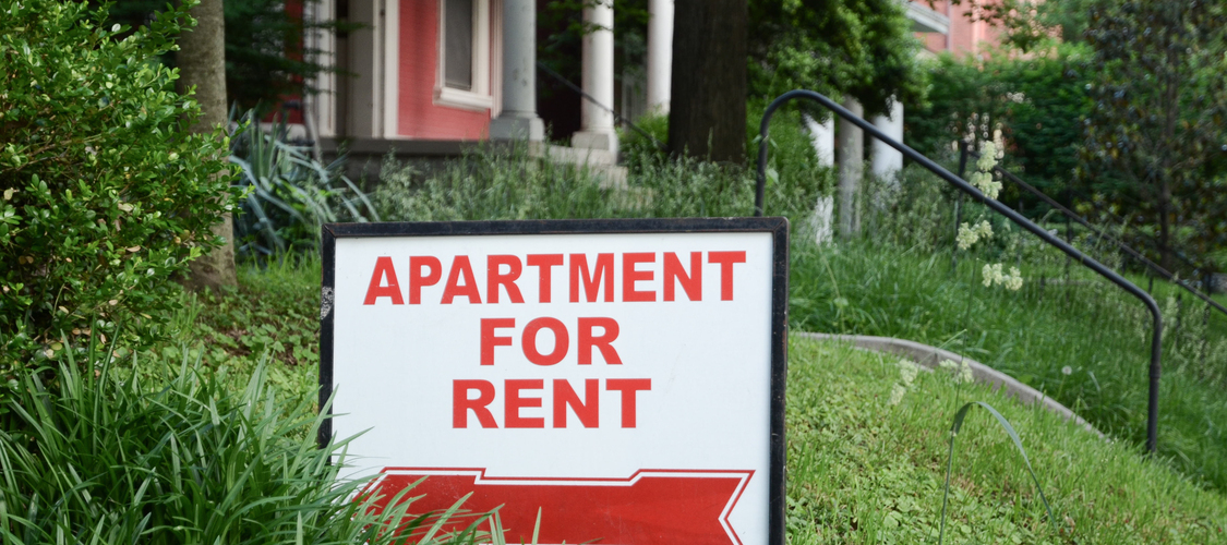 A sign on a yard in front of a home that says