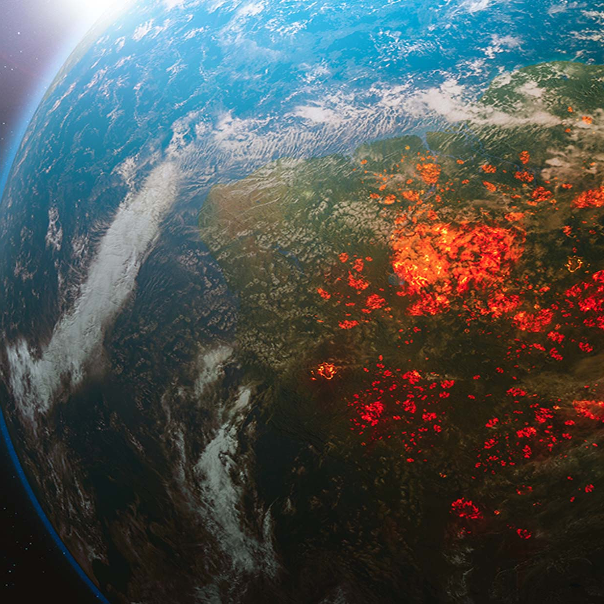 View of Earth from space showing widespread wildfires glowing red across a large land area