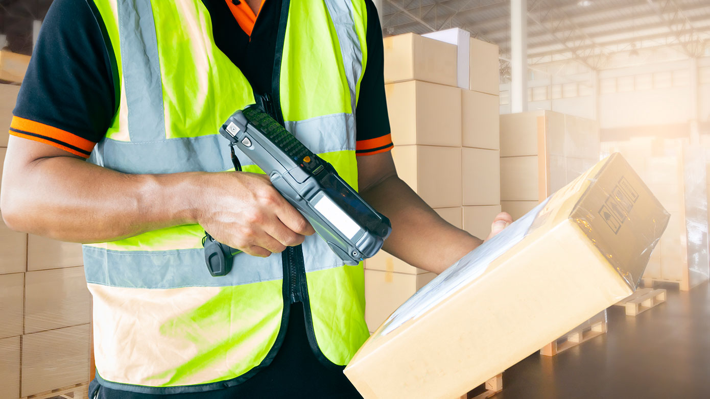 imagecard_end-user-enablement.jpg Man with barcode delivery scanner