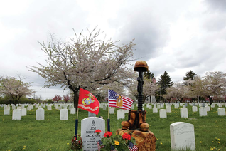 A battlefield cross carved by Anthony Marquez stands by the grave of Marine Lance Cpl. Joe Jackson in Tahoma National Cemetery in Yakima, Wash. Jackson was killed by an improvised bomb while conducting combat operations in Helmand Province, Afghanistan, on April 24, 2011.