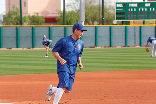 Father Burke Masters, chaplain of the Chicago Cubs, rounds third base during a workout with the team at their spring training complex in Mesa, Ariz., in March 2016. (Photo by Edward Maillard)