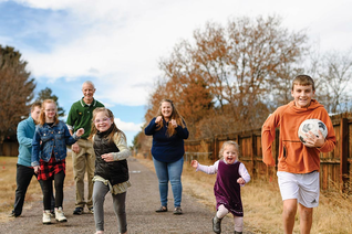 Jeff and Sonia McGarrity take a stroll with five of their eight children outside their home near Lone Tree, Colo. (Photo by Ryan Dearth)