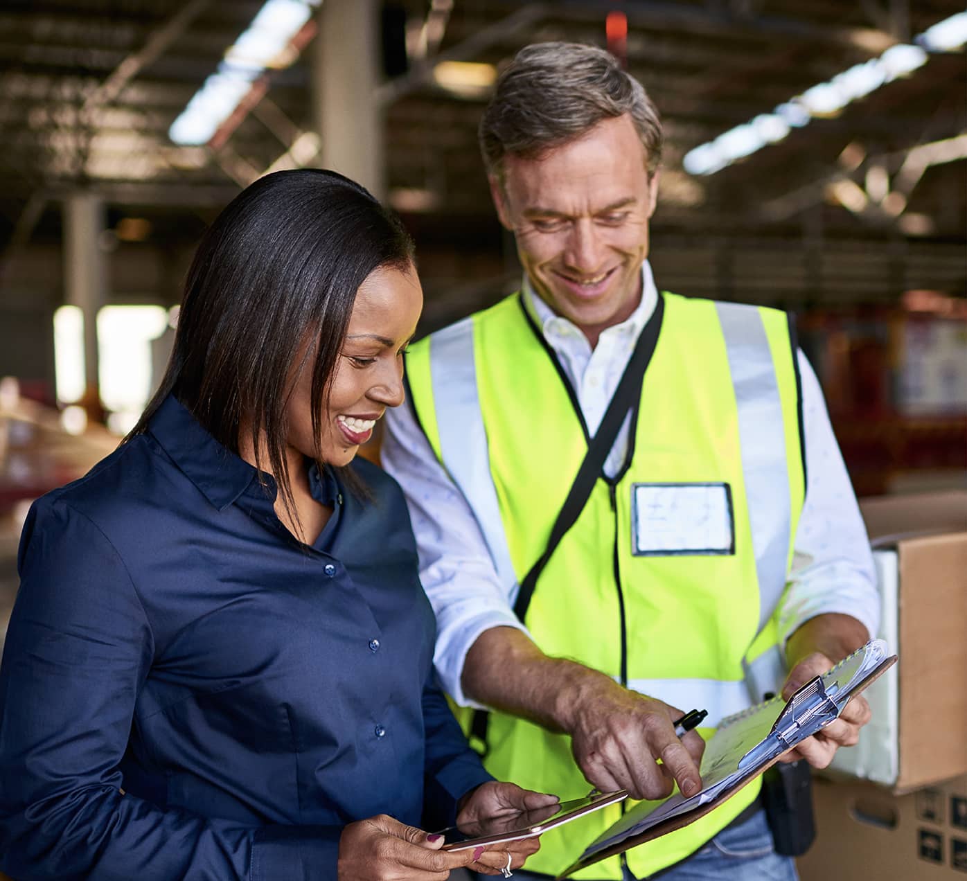 Warehouse workers reading off a clipboard