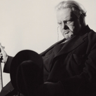 Chesterton sits for a portrait by British photographer Howard Coster
