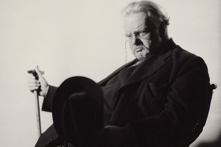 Chesterton sits for a portrait by British photographer Howard Coster