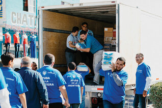 Knights unload food and supplies for the migrant families at the Casa del Migrante in Matamoros, Mexico, Dec. 13.