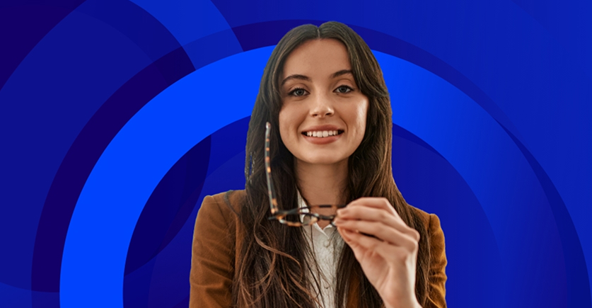 The image is a portrait of a smiling woman with long brown hair, looking directly at the camera. She is wearing a brown jacket over a white shirt. She is holding a pair of tortoiseshell-framed glasses in her right hand, positioned near her face. The background is an abstract, vibrant design consisting of overlapping concentric circles in various shades of blue, giving the image a modern and dynamic feel. The overall impression is professional and welcoming.