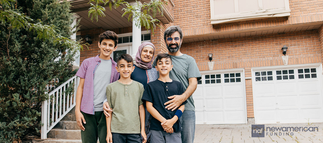 family standing in front their home