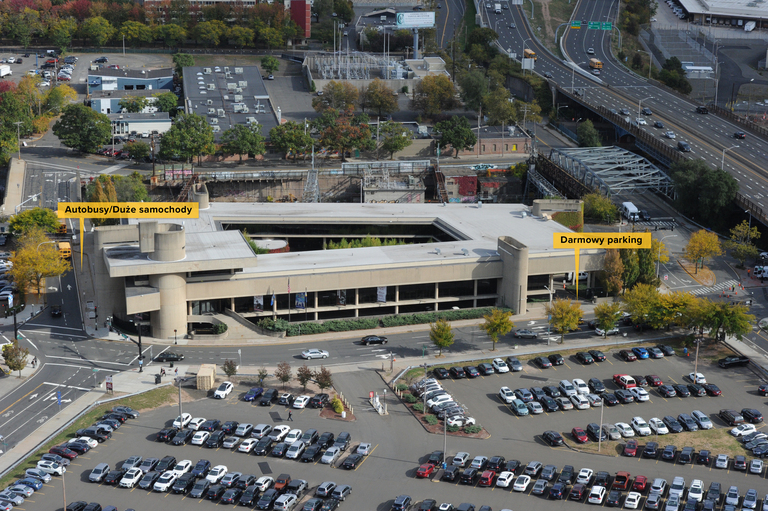 Aerial photo of the McGivney Pilgrimage Center enhanced to indicate in Polish the bus and van parking along with the free parking beneath the building. 