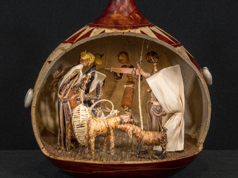 Crèche from Kenya housed in a hallowed out dried African gourd. The figures inside include the Holy Family, two goats, three wise men and a villager.