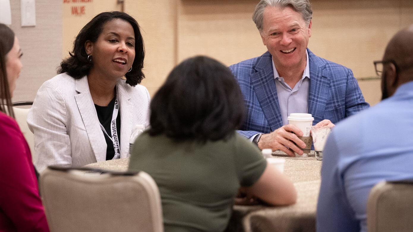 A group of people around a round table