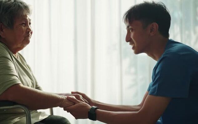 patient holding hands with occupational therapist