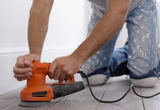 Man using orbital sander