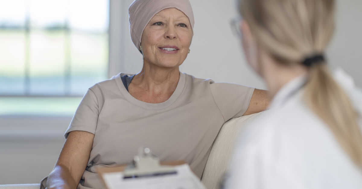 cancer survivor speaks with healthcare professional