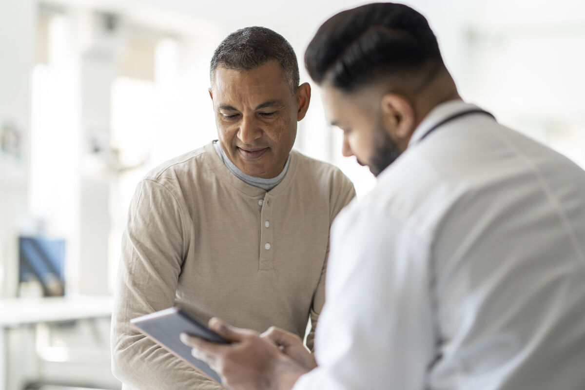 patient reviews medical records with healthcare professional