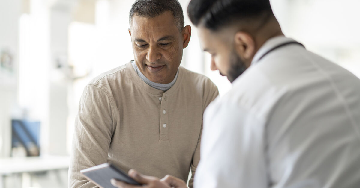 patient reviews medical records with healthcare professional