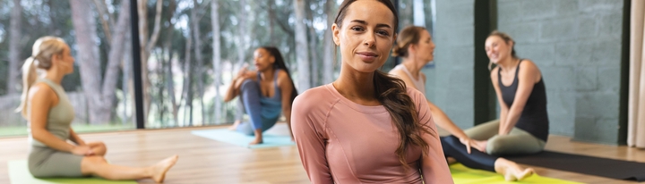 Women sitting in a yoga studio.